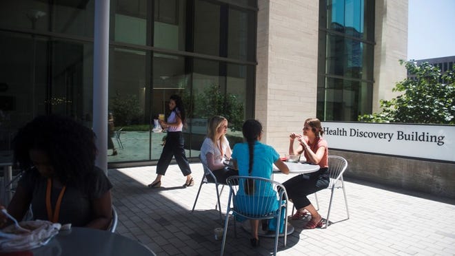 Adeola Akinfaderin, far left, Michelle Flood, middle, Stephanie Anderson, middle right, and Stephanie Morgan, right, eat lunch outside the Dell Medical School Health Discovery Building on Wednesday, July 18, 2018 in Austin, TX.