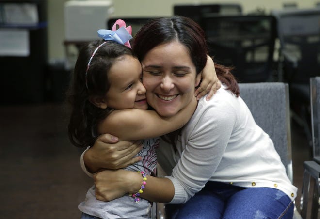 Immigrants seeking asylum Natalia Oliveira da Silva and her daughter, Sara, 5, hug as they wait at a Catholic Charities facility, Monday, July 23, 2018, in San Antonio. Bethany Christian Services, a Grand Rapids-based nonprofit, announced Thursday that 90 percent of the children in their care who had been separated from their families at the border had been reunited. [AP Photo/Eric Gay]