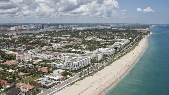 Palm Beach’s Midtown Beach is dotted with white side-by-side condominium buildings. Just released second-quarter sales reports show an increase in condo sales in Palm Beach. Photo by Brian Lee, courtesy WoollyMammothPhoto.com