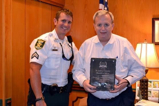 Cpl. Troy Bickhart presents St. Johns County Sheriff David Shoar with the agency's third place plaque won in this year's Florida Law Enforcement Traffic Safety Challenge.