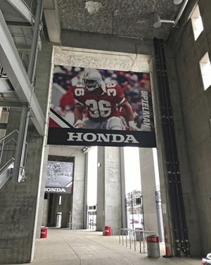 A Chris Spielman banner with a Honda logo, a key element in his lawsuit against Ohio State, hangs in Ohio Stadium during a 2016 game. A similar banner featuring Archie Griffin is in the background. [Photo courtesy of Kevin Schlosser]