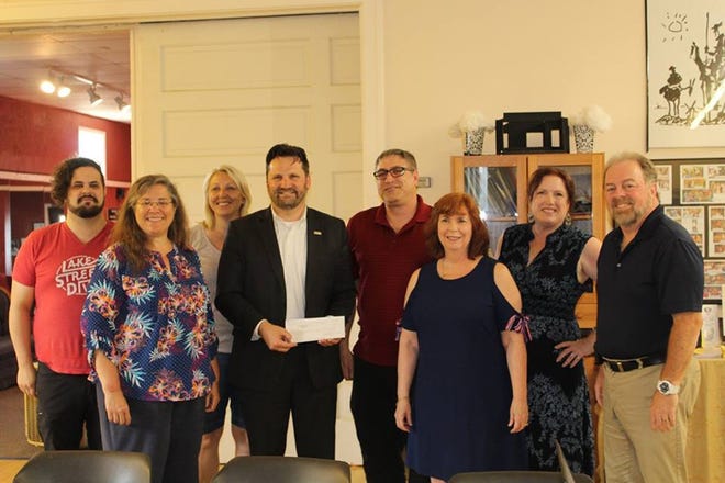 Jason Reimink, Laurie Van Ark, Jodi Miller, Ryan Powers (from LAROC), Jim Griffin, Sue Ann Culp, Debbie Ruth and Michael Culp presented a check to Powers for the Lakeshore Area Radiation Oncology Center in Holland. [CONTRIBUTED}