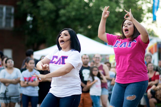 Sharlotte Gramajo, left, and Brenda Lozano compete in a dance competition with other Sigma Lambda Gamma members at Fiesta Friday on Capitol Hill in Oklahoma City, Friday, July 27, 2018. The theme of the July 27 Fiesta Friday was Back to School Bash, so Greek life from local schools came and competed in a dance competition. The summer block parties will run on Fridays through August in Oklahoma City, between SW 25th and SW 24th on Harvey Ave. Photo by Anya Magnuson, The Oklahoman
