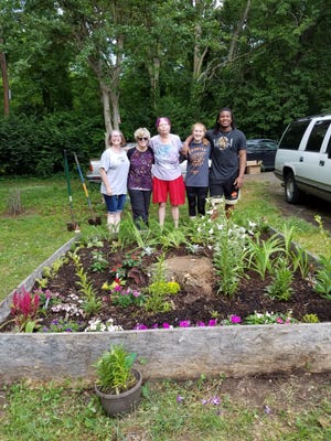 Cynthia Gould, Joanie Mabry, Penny Foster, Leah Elliott and Eddie Studyvance in front of Penny Foster's new flowerbox. [Special to The Star]