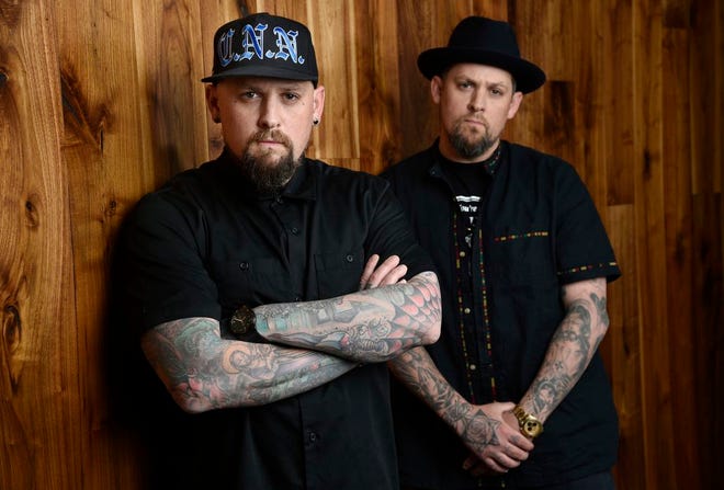 This July 10, 2018 file photo shows Benji Madden, left, and his twin brother Joel Madden of the rock band Good Charlotte in Burbank, Calif. The city of Annapolis, Md. will hold a benefit concert on July 28 featuring the Maryland-based band to honor the five Capital Gazette employees killed in an attack in their newsroom. (Photo by Chris Pizzello/Invision/AP)