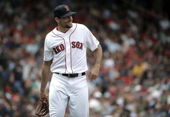 New Red Sox pitcher Nathan Eovaldi is all smiles as he steps off the mound in the fourth inning of Boston's 3-0 win over the Minnesota Twins on Sunday in Boston. [AP Photo/Steven Senne]