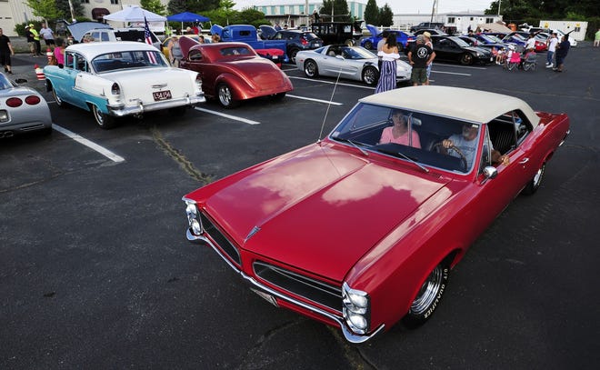 A 1967 Pontiac Lemans heads out of the lot during the monthly Cruise Night held at New Bedford Airport. [DAVID W. OLIVEIRA/STANDARD-TIMES SPECIAL/SCMG]