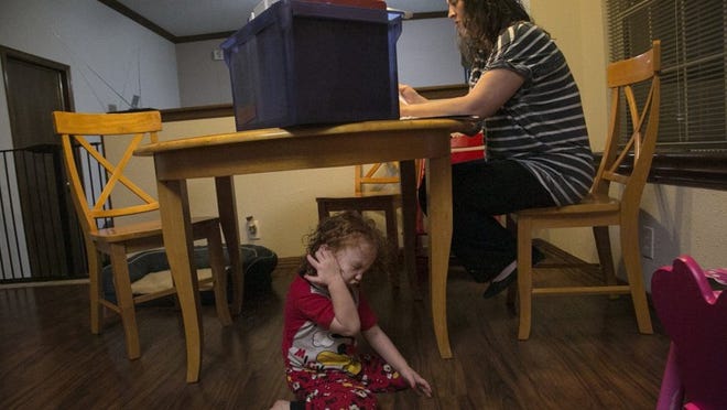 Jill Bradshaw discovered this month that Central Texas Pediatric Orthopedics, the only specialist of its kind in the Austin area that accepts Medicaid, would no longer accept her daughter’s Medicaid plan with Blue Cross and Blue Shield. Bradshaw is pictured on Oct. 15, 2017, looking through a box of medical paperwork for her daughter, who has disabilities. RESHMA KIRPALANI / AMERICAN-STATESMAN