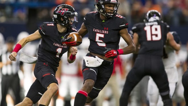 Lake Travis wide receiver Garrett Wilson (5) takes a handoff from backup quarterback Hudson Card (1) against Allen in the Class 6A Division I title game last season. Both return to lead the Cavs’ offense. (Erich Schlegel/Special Contributor)