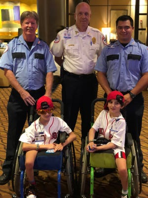 BOSTON/ Brewster Ambulance staff Dennis McMorrow, specialty transport driver, Daniel Thomas, Boston division manager, and Jacob Hurtz, an EMT, pose with the twins, Hassan (left) and Hussein (right), at the Westin Copley on Monday, July 30, Johnathon Bobbit-Miller/Brewster Ambulance Service.