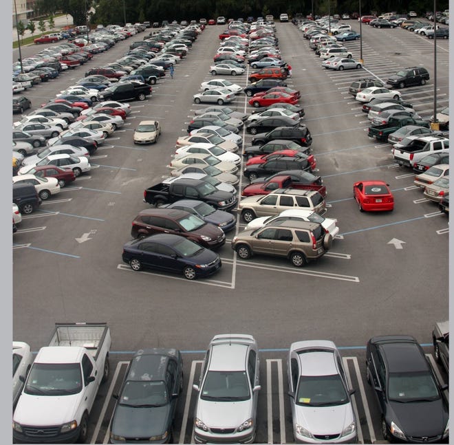 Drivers search for parking at the commuter lot on Gale Lemerand Drive in this undated file photo. Starting Aug. 16, University of Florida transportation officials will enforce new rules, including a ban on overnight parking between 3 a.m. and 5 a.m. in "Any Decal" lots. The rules are meant to free up desperately needed parking spaces.