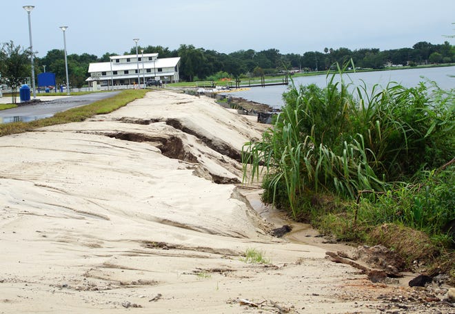 A number of deep ruts cut through the newly laid sand at Clermont's Victory Pointe event venue. Heavy rains have caused the sand to run off into the lake. [LINDA CHARLTON / CORRESPONDENT]