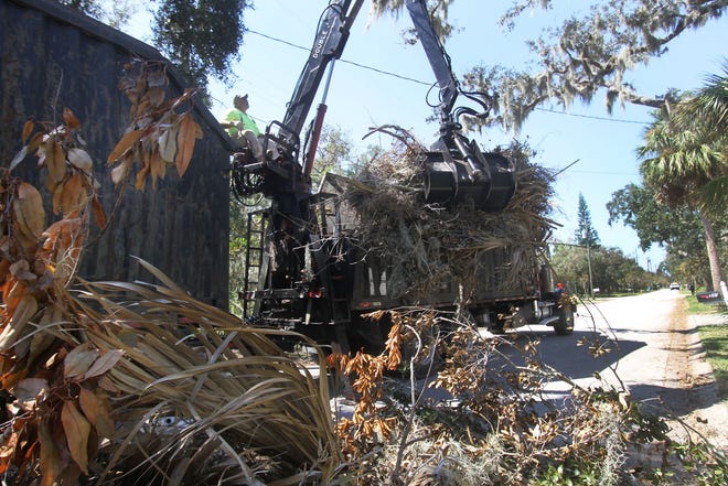 Efforts to pick up the debris left by Hurricane Irma have begun in several Volusia County cities, including Ormond Beach and Edgewater. Crowder-Gulf, the debris contractor for Ormond Beach, was working on South Washington Street Tuesday. Shown, Brad Bradshaw grabs storm debris from the side of the street to load it into the truck. [News-Journal file/David Tucker]