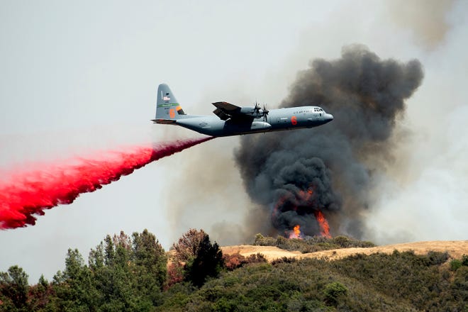 An air tanker drops retardant on the River Fire burning near Lakeport, Calif., on Tuesday, July 31, 2018. (AP Photo/Noah Berger)