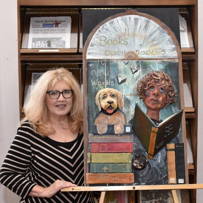 Photo by Terry Barnhill

Peggy Sibila poses with her three-dimensional art at the Tuscarawas County Public Library.