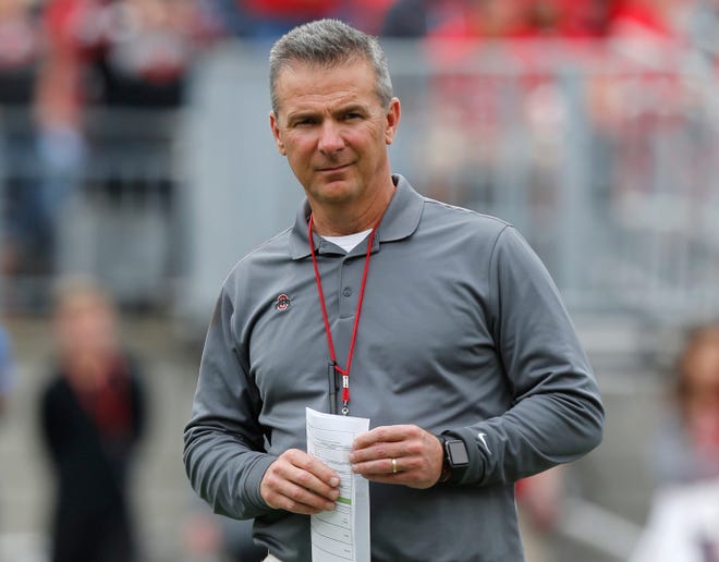 FILE - In this April 14, 2018, file photo, Ohio Setate coach Urban Meyer watches the NCAA college football team's spring game in Columbus, Ohio. Ohio State has placed Meyer on paid administrative leave while it investigates claims that his wife knew about allegations of abuse against an assistant coach years before he was fired last week. [AP Photo/Jay LaPrete, File]