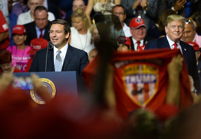 Ron DeSantis, left, GOP candidate for Florida governor, speaks at a rally with President Donald Trump in Tampa on Tuesday. DeSantis is battling Florida Commissioner of Agriculture Adam Putnam for the Republican gubernatorial nomination. [GateHouse Florida/Dan Wagner]