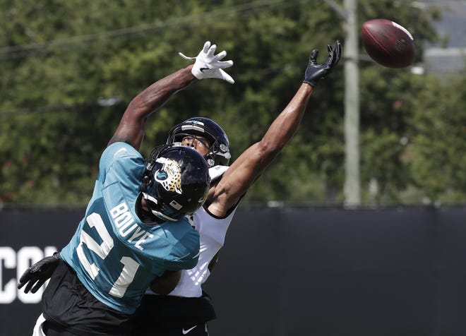 Jaguars cornerback A.J. Bouye (21) breaks up a pass intended for receiver Keelan Cole during a practice Wednesday. [AP Photo/John Raoux]