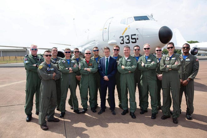 Secretary of State for Defence, Right Honourable Gavin Williamson (center) gather in front of a P-8A Poseidon with members of Patrol Squadron 30 at Royal International Air Tattoo (RIAT) at Royal Air Force Fairford in Gloucestershire, England. RIAT is one of the biggest air shows internationally, attracting aircraft and crews from around the globe.