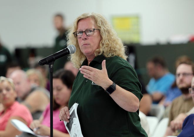 Photo by Daniel Freel/New Jersey Herald - Sue Hill, president of the Hopatcong Education Association, speaks during the public comment portion of a Board of Education meeting on Monday in Hopatcong. About 100 educators, school staff, faculty and supporters attended the meeting to show their opposition to the board's approval of staffing cuts following a recently announced reduction in state aid for the 2018-2019 school year.