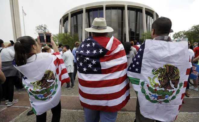 In this June 26, 2017, file photo, protesters take part in a rally to oppose a new Texas "sanctuary cities" bill that aligns with the president's tougher stance on illegal immigration, in San Antonio, Texas, outside of the Federal Courthouse. A U.S. appeals court says President Donald Trump's executive order threatening to withhold funding from "sanctuary cities" that limit cooperation with immigration authorities is unconstitutional. But the 9th U.S. Circuit Court of Appeals on Wednesday, Aug. 1, 2018, said a lower court went too far when it blocked the order nationwide. (AP Photo/Eric Gay, File)