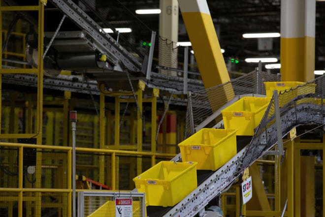 Yellow bins move up a conveyor belt at the Amazon.com Inc. fulfillment center in Robbinsville, New Jersey, on June 7, 2018. MUST CREDIT: Bloomberg photo by Bess Adler.