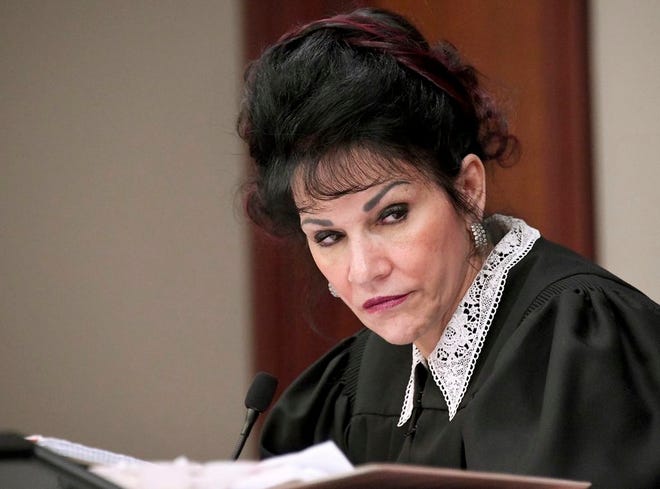 FILE - In this Jan. 23, 2018 file photo, Judge Rosemarie Aquilina listens to a victim statement during the sixth day of Larry Nassar's sentencing hearing in Lansing, Mich. The Michigan attorney general's office is defending the conduct of Larry Nassar's sentencing judge and asking that she deny a defense request to disqualify herself from the former Michigan State University sports doctor's appeal. The Detroit News reports that the attorney general's office says in court documents filed Tuesday, July 31, 2018, that Judge Aquilina's role was different than a trial judge when she sentenced Nassar after he pleaded guilty to molesting women and girls under the guise of medical treatment. (Dale G. Young/Detroit News via AP, File)
