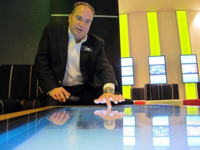 Mark Giannantonio, president of Resorts Casino Hotel in Atlantic City N.J., demonstrates a tabletop internet gambling console at his casino in 2015. On Thursday, Resorts announced its second online sports betting deal in as many days. The casino has partnered with DraftKings and The Stars Group to offer sports betting, and is the first to be approved for online and mobile sports betting in New Jersey. [WAYNE PARRY / THE ASSOCIATED PRESS]