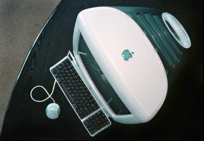 In this Aug. 13, 1998, photo, Apple's new iMAC computer is seen at Apple headquarters in Cupertino, Calif. Apple, which teetered on the edge of bankruptcy in 1997, has come a long way since then. It is now the world's first publicly traded company to be valued at $1 trillion, the financial fruit of tasteful technology that has redefined society.  [AP file photo]