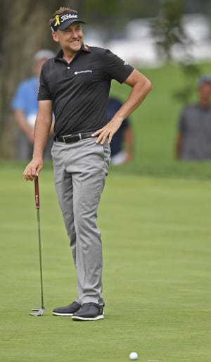 Ian Poulter, from England, reacts after missing a putt on the eighth hole during the first round of the Bridgestone Invitational golf tournament at Firestone Country Club on Thursday in Akron, Ohio. (AP Photo/David Dermer)