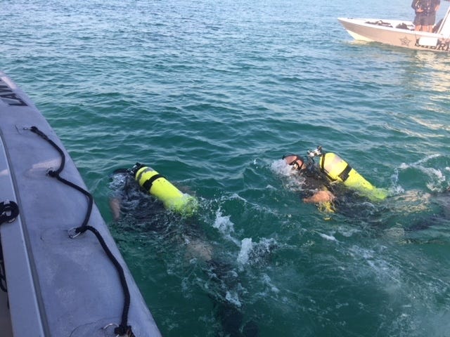 Divers with the Okaloosa County Sheriff Office look for the body of a drowned teenager earlier this month. [OCSO/CONTRIBUTED PHOTO]