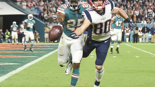 New England Patriots wide receiver Danny Amendola (80) cannot make a reception as he is covered by Miami Dolphins cornerback Xavien Howard (25) during the second half of the game between the New England Patriots and the Miami Dolphins at Hard Rock Stadium in Miami Gardens, Fla., on Monday December 11, 2017. Final score, Miami 27, New England, 20. (Andres Leiva / The Palm Beach Post)