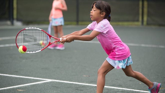 Siena Ethridge, of Palm Beach Gardens, practices hitting a tennis ball during a little pros tennis summer camp at the Palm Beach Gardens Tennis Center. (Madeline Gray/The Palm Beach Post file photo)