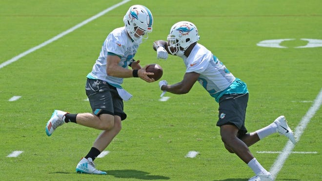 Miami Dolphins quarterback Ryan Tannehill #17 handoff to Dolphins running back Kenyan Drake #32 during the Miami Dolphins Organized Team Activities at the Baptist Health Training Facility at Nova Southeastern University on Tuesday, June 5, 2018 in Davie.