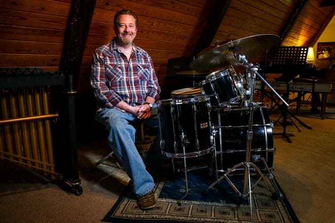 Music instructor Loyd Warden poses for a portrait behind his drum set at his studio on Wednesday, August 1, 2018. Warden teaches a variety of music styles, including jazz and R&B, in his A-frame studio. [Hunter Dyke/Tribune]