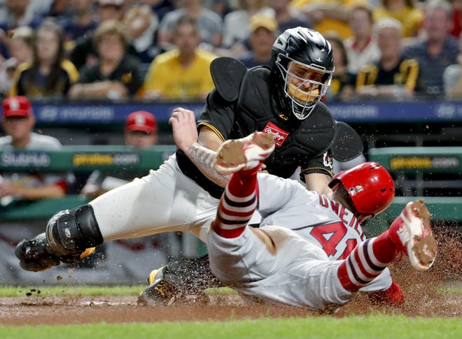 Pittsburgh Pirates catcher Francisco Cervelli, top, tags out St. Louis Cardinals' Tyler O'Neill during the eighth inning of a baseball game Friday in Pittsburgh. [Keith Srakocic/The Associated Press]