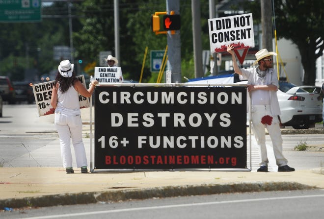 Members of Bloodstained Men were at Dover's Week's Crossing on Thursday protesting against male circumcision at birth.
[Deb Cram/Fosters.com]