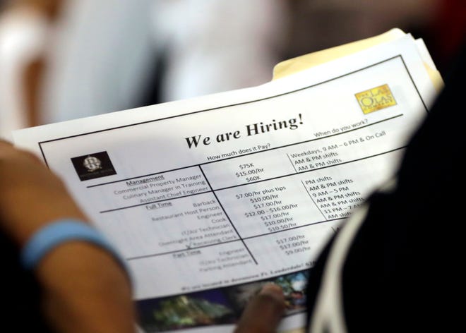 In this June 21, 2018 file photo, a job applicant looks at job listings for the Riverside Hotel at a job fair hosted by Job News South Florida, in Sunrise, Fla. Economists forecast that employers added 191,000 jobs in July, down from 213,000 in June but easily enough to lower the unemployment rate over time. The jobless rate is projected to decline to 3.9 percent, near an 18-year low, from 4 percent. The Labor Department’s monthly jobs report will be released at 8:30 a.m. Eastern Friday, Aug. 3. (AP Photo/Lynne Sladky)