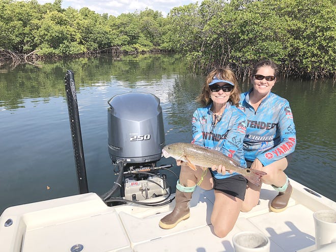 Leiza Fitzgerald, STAR director, and Andrea Gillespie, assistant STAR director, release a tagged redfish for the 2018 Statewide Tournament Anglers Rodeo competition, which continues through Labor Day. [CONTRIBUTED]