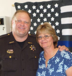 Cervantez with Sheriff Kerry Loncka, left, at Sue's retirement party last month.