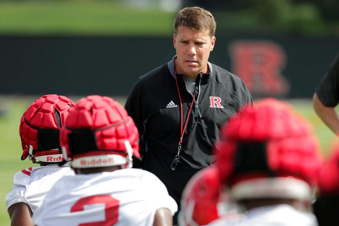 Rutgers head coach Chris Ash, center, talks to running backs as they stretch during NCAA college football training camp, Friday, Aug. 3, 2018, in Piscataway, N.J. (AP Photo/Julio Cortez)
