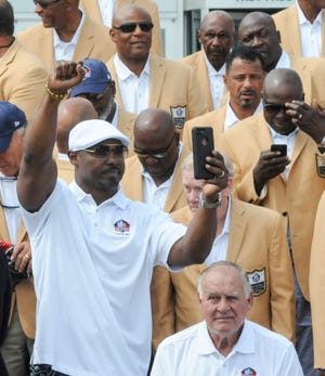 Brian Dawkins stands up to take a selfie during the Gold Jacket Photo Opportunity event Friday, August 3, 2018 on the front steps of the Pro Football Hall of Fame. (CantonRep.com / Michael Balash)