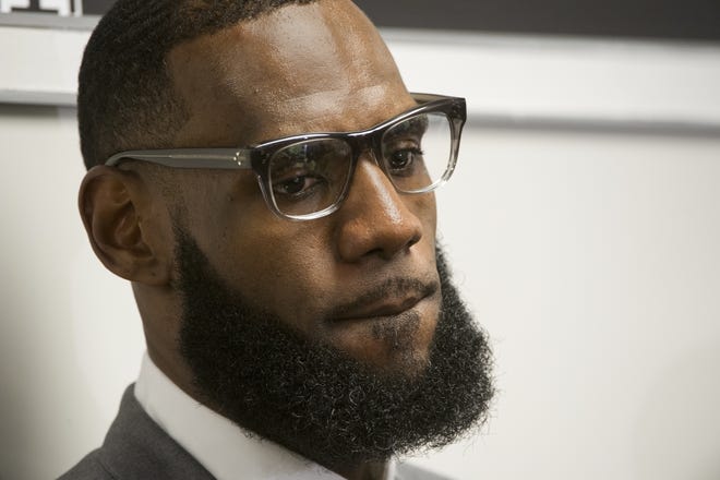 LeBron James listens to a question at a news conference after the opening ceremony for the I Promise School Monday in Akron, Ohio. [AP Photo/Phil Long, File]