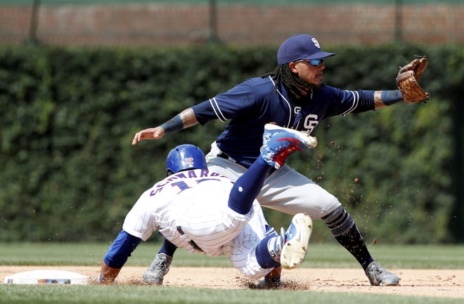 San Diego Padres shortstop Freddy Galvis, right, waits on the throw as Chicago Cubs left fielder Kyle Schwarber slides in safely to second base during the fifth inning of Saturday's game in Chicago. [AP Photo/Jeff Haynes]
