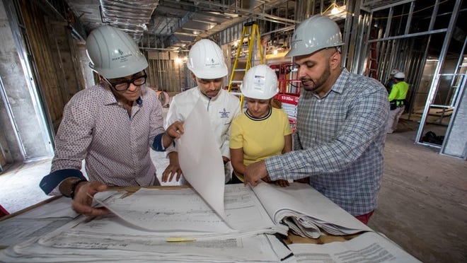 From left: Mohamed Elbanna, general manager; Jose Gamez, executive chef; Randa Lao, director of engineering; and Mazen Saleh, resort manager, review blueprints and discuss plans for the interior and operational layout of the Four Season Resort’s new restaurant space. (Damon Higgins / Daily News)