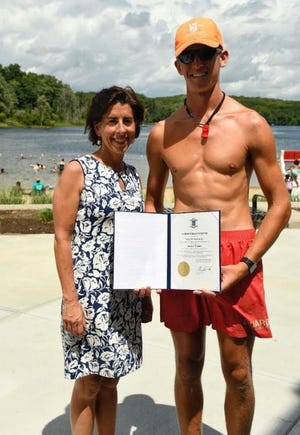 Governor Gina Raimondo presented DEM lifeguard Andrew Turner with a citation for rescuing a swimmer Thursday at Lincoln Woods State Park. [DEM photo: Mike Stultz]