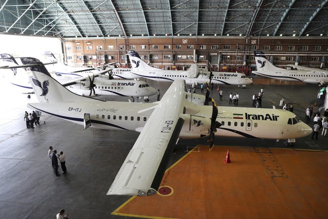 In this photo provided by Tasnim News Agency, Iran Air's new commercial aircrafts are parked at Mehrabad airport in Tehran, Iran, Sunday, Aug. 5, 2018. Iran has acquired five new ATR72-600 airplanes from ATR, jointly owned by European consortium Airbus and Italy's Leonardo, a day before the U.S. begins restoring sanctions suspended under the 2015 nuclear deal. (Mohammad Hassanzadeh/Tasnim News Agency via AP)