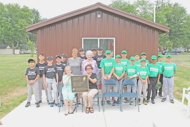 Members of the Bronson Little League teams from Mill Supply/Lakeside Farms and Bronson Business Service pose with Barb Bucklin, Judy Hurley, Ann Houghton, and Beverly Carpenter during the dedication of the new concession stand at the little league diamonds in Bronson.