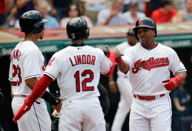 Cleveland Indians' Jose Ramirez, right, is congratulated by Francisco Lindor and Michael Brantley after hitting a three-run home run in the first inning of a baseball game against the Los Angeles Angels, Sunday, Aug. 5, 2018, in Cleveland. (AP Photo/Tony Dejak)