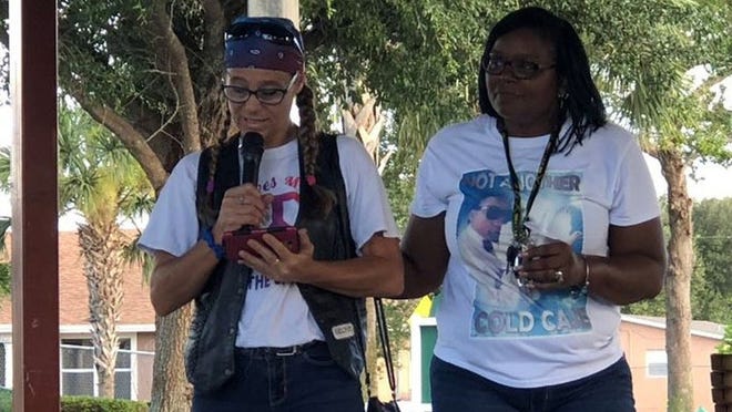 Sharon Dunbar, mother of Se’Sawn Danford, comforts Tracey Cassady, godmother of Carley Chapman, as Cassady reads a poem at a vigil in Goodmark Park in Riviera Beach on the fourth anniversary of the teens’ murder. Danford, Chapman and Martavious Brown were fatally shot in their Mangonia Park apartment Aug. 4, 2014. Police haven’t found their killer or killers. Their families hold a vigil every year to bring attention to the unsolved murders and prevent it from becoming a “cold case.” (Sarah Peters/The Palm Beach Post)